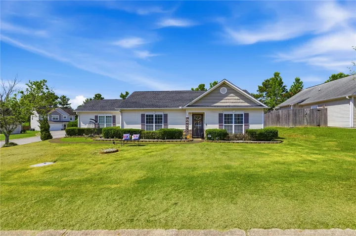A well-maintained facade with neat landscaping and a generous lawn.