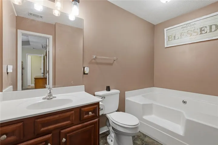 A well-appointed bath with a pristine vanity and a relaxing soaking tub.