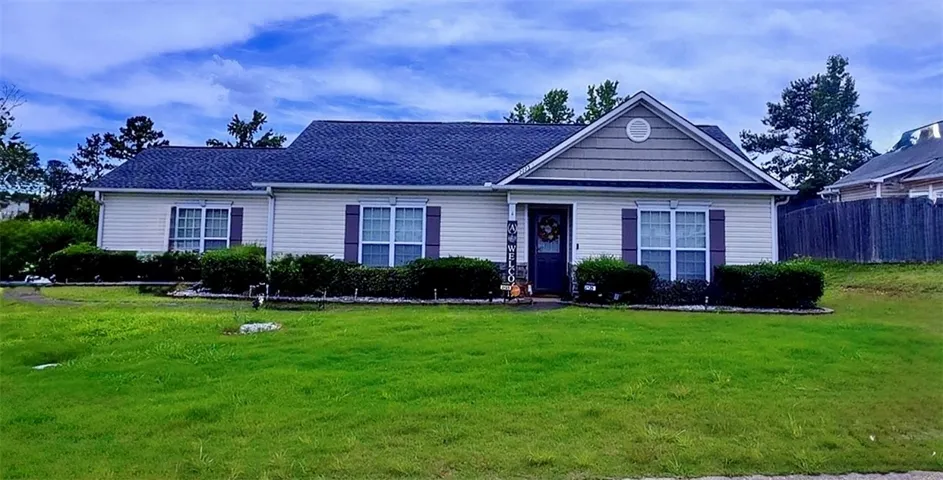 A well-maintained ranch home with a neatly manicured lawn awaits its new owners.