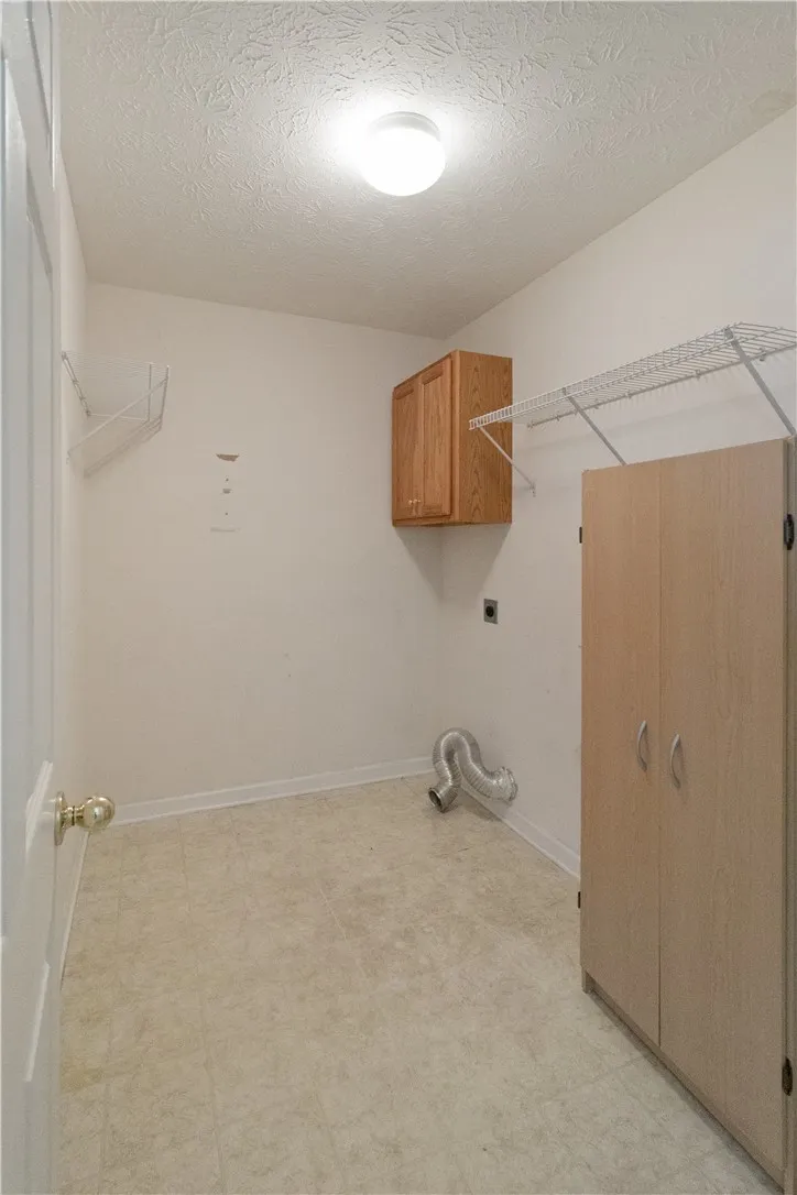 Functional utility room with ample storage and accessible laundry hookups.