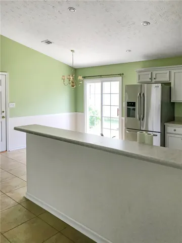 A functional kitchen space offers direct outdoor access through sliding glass doors.