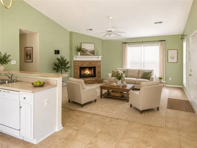 Virtual Staging. A welcoming living space features a cozy fireplace and convenient pass-through to the kitchen.