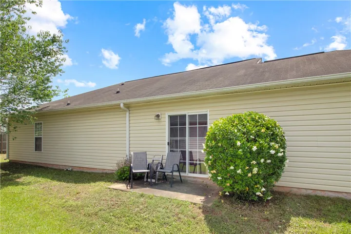 A tranquil rear patio offers an inviting outdoor retreat with direct access to the interior.