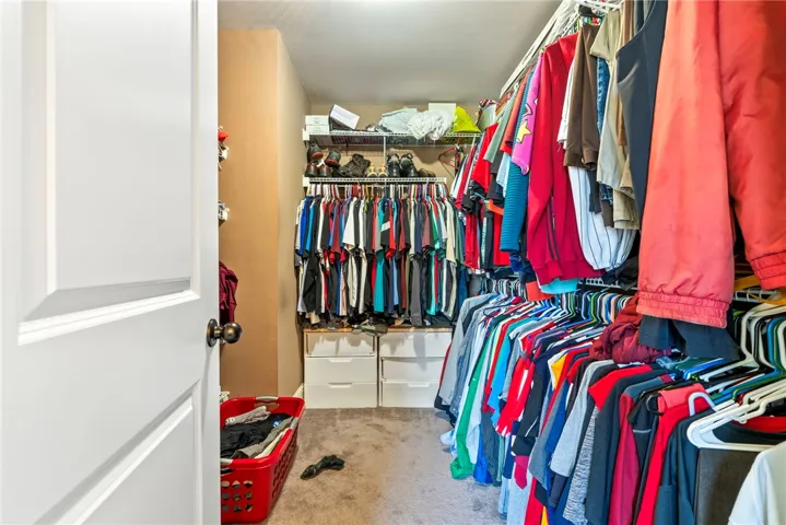 Functional closet space offers ample storage with hanging rods and convenient shelving for organization.