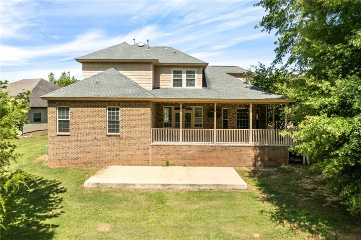 A spacious brick residence with an inviting rear porch, perfect for enjoying outdoor moments.