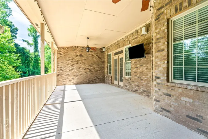 A spacious covered patio invites outdoor entertaining with verdant views.