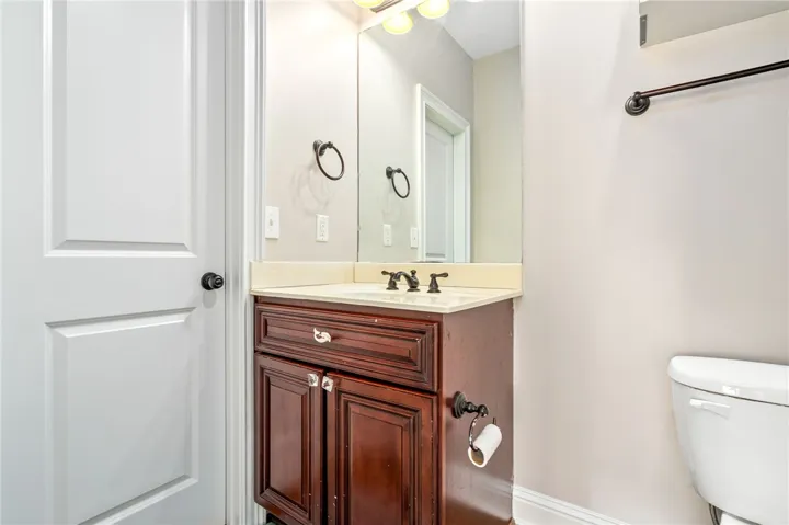 Functional vanity with a rich wood finish and a sleek countertop.