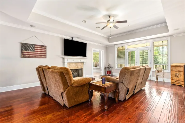 Hardwood floors and an inviting fireplace anchor this elegant living space.