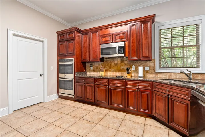 Rich wood cabinetry and a functional layout define this well-appointed kitchen.