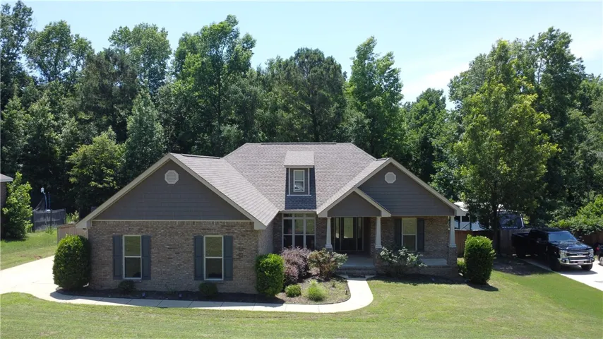 A well-maintained facade with brick accents and a dormer window welcomes you home.