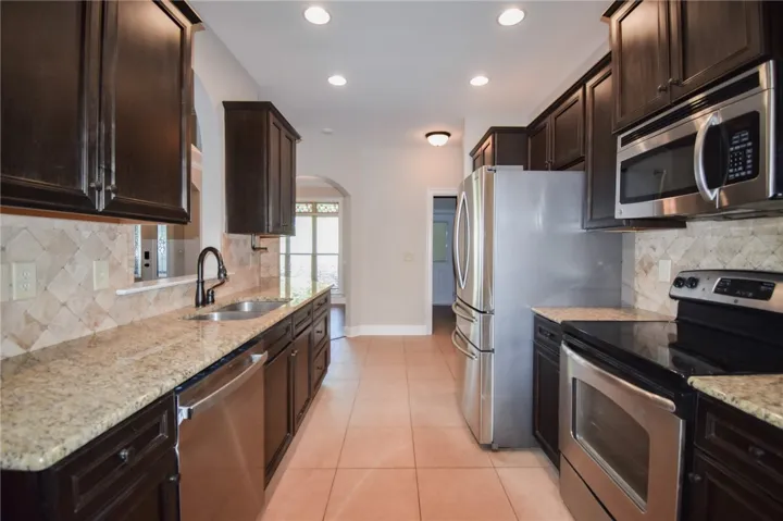 A galley kitchen boasts sleek appliances and ample counter space.