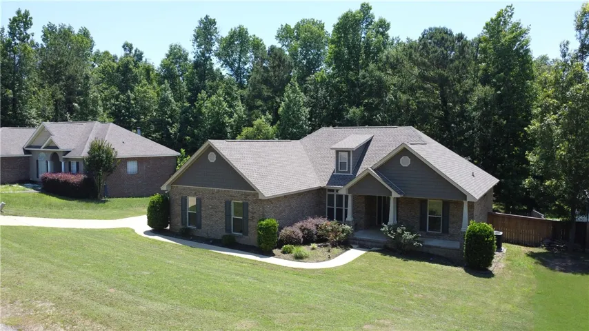 A classic brick exterior with tasteful grey siding accents offers enduring curb appeal.