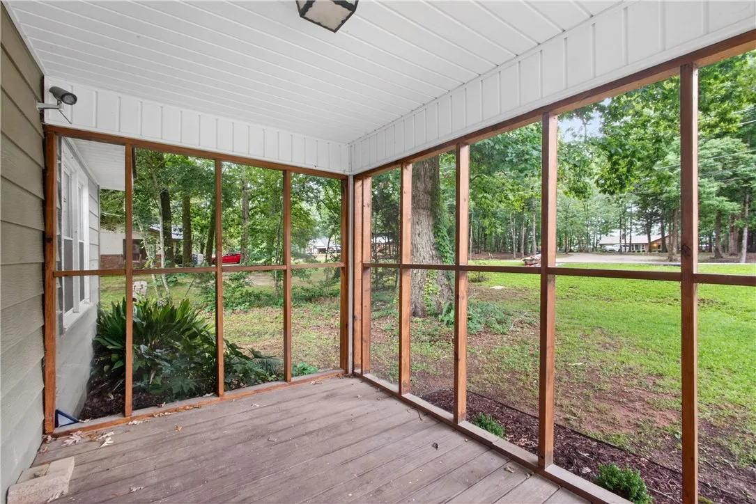This lovely front porch is screened for added privacy.