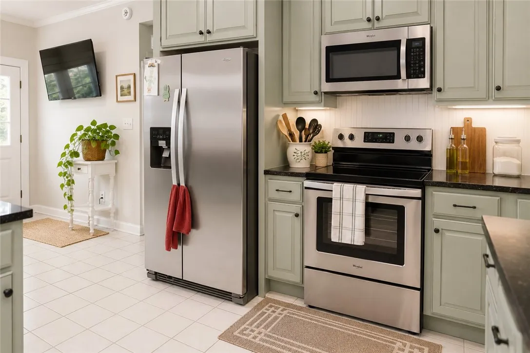 A well-equipped kitchen features sleek stainless steel appliances and light-toned cabinetry.