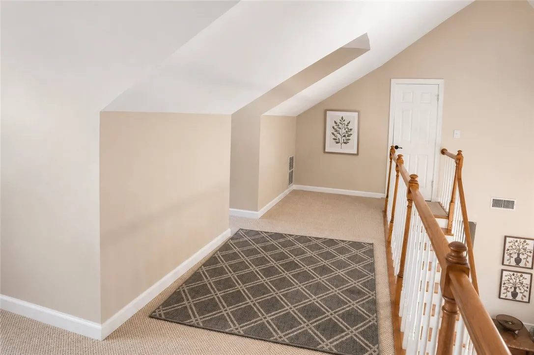 An inviting upper-level landing, perfect for quiet reflection or a cozy reading nook.