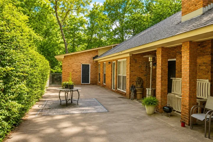 An inviting brick patio extends from this charming residence, perfect for outdoor leisure.