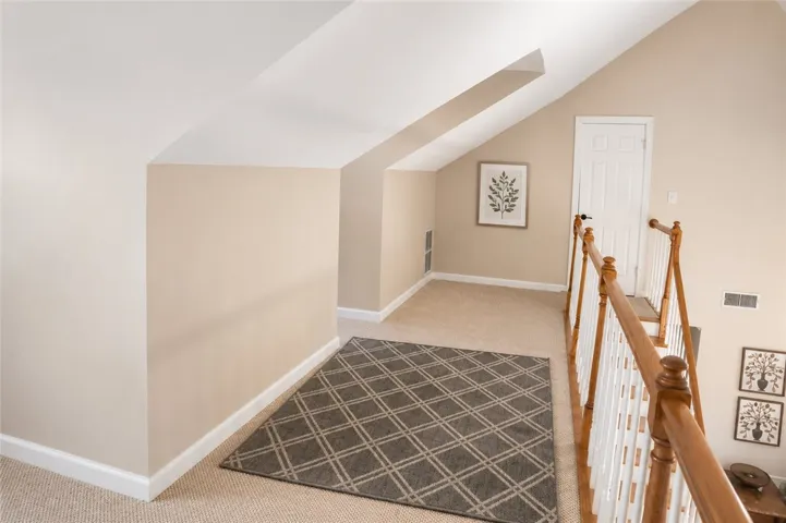 An inviting upper-level landing, perfect for quiet reflection or a cozy reading nook.