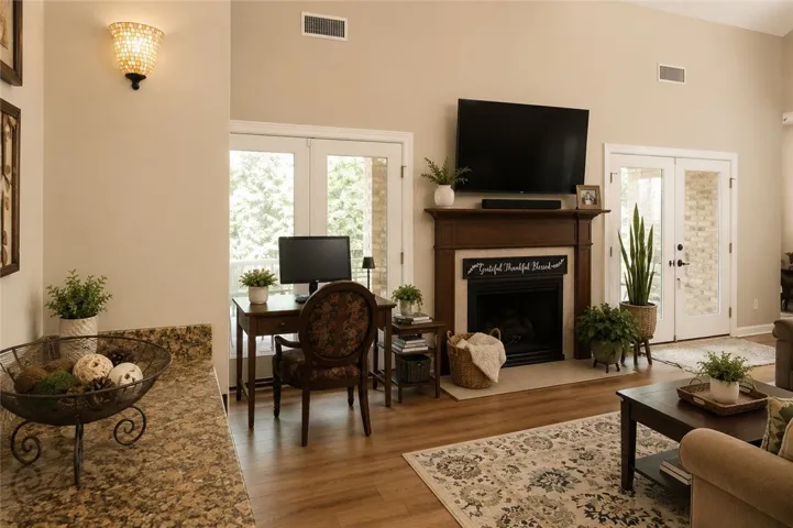 A well-lit living area showcases a cozy fireplace and convenient outdoor access.