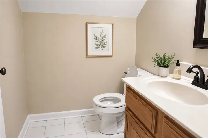A well-appointed lavatory offers a sleek vanity with modern fixtures and tile flooring.