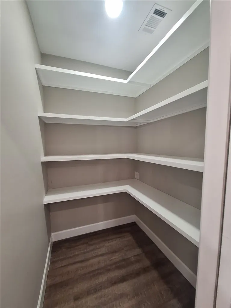Ample built-in shelving provides generous storage space for kitchen essentials.