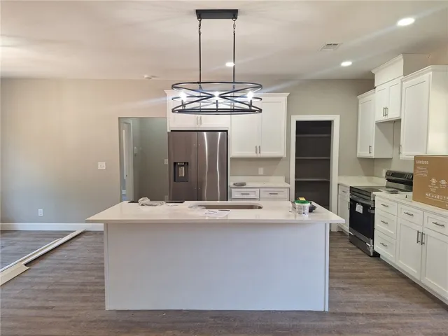 A well-appointed kitchen showcasing a central island and modern appliances.