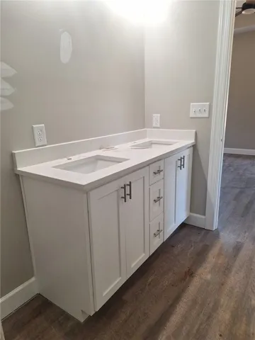 Double vanity with quartz countertops and sleek white cabinetry awaits in this refreshed bathroom.