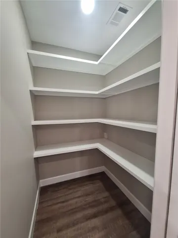 Ample built-in shelving provides generous storage space for kitchen essentials.