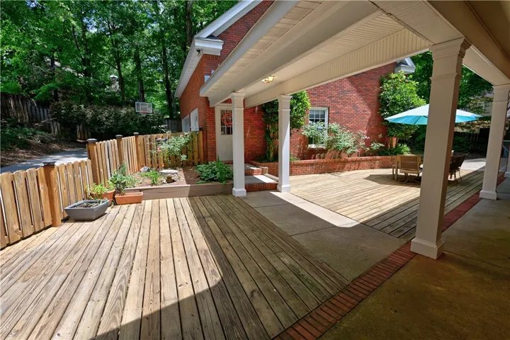 Deck with walkway leading to garage & above-garage apartment.