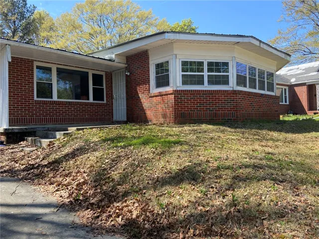 A classic brick exterior with a distinctive bay window offers charming curb appeal.