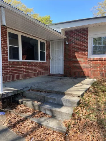 A classic brick exterior offers enduring charm and a secure entry.