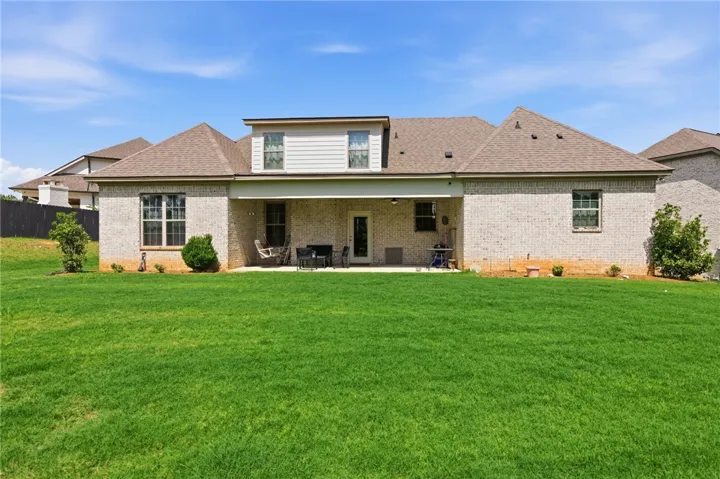 A spacious backyard with a private covered patio, ideal for outdoor leisure.