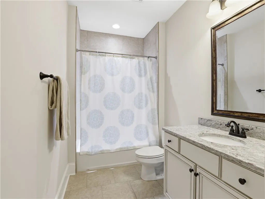 A well-appointed bathroom with contemporary fixtures and a light color palette awaits.