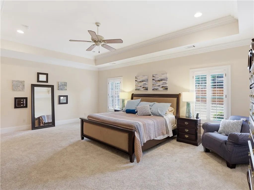 A spacious sleeping quarter features a vaulted ceiling and ample natural illumination from window treatments.