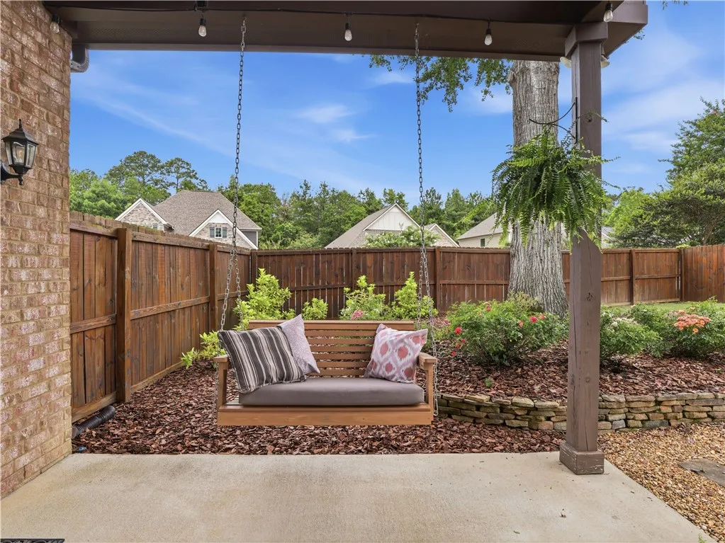 Relax on the inviting porch swing, nestled within a private fenced yard.