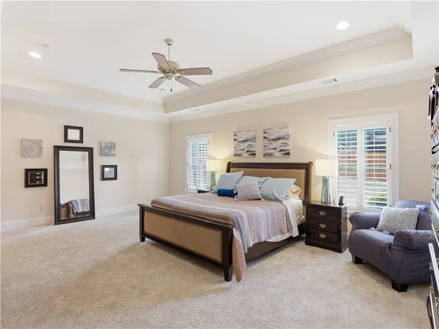 A spacious sleeping quarter features a vaulted ceiling and ample natural illumination from window treatments.
