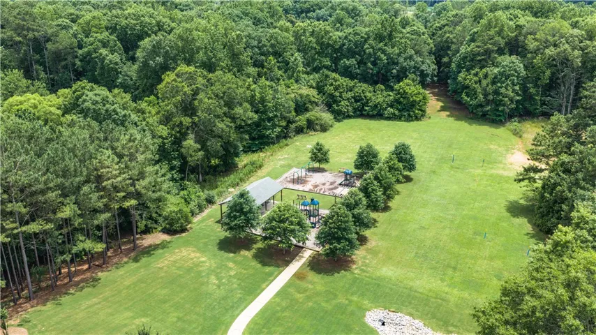 A well-maintained park area featuring a playful playground and covered shelter for community enjoyment.