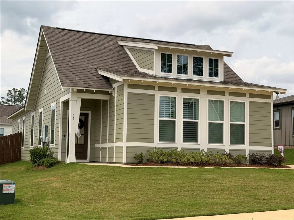 Cement board siding offers a low-maintenance exterior with a dormer window accent and covered porch.