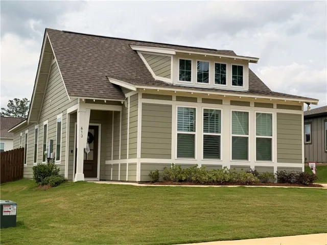 Cement board siding offers a low-maintenance exterior with a dormer window accent and covered porch.