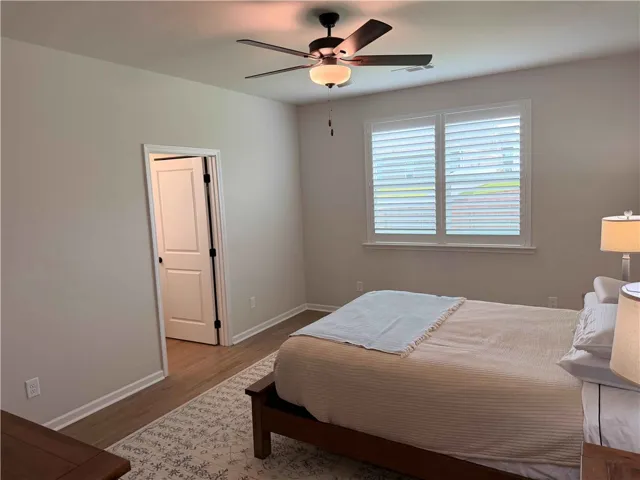 Natural illumination fills this room, complemented by a convenient ceiling fan for optimal comfort. Plantation shutter treatments. 15x16