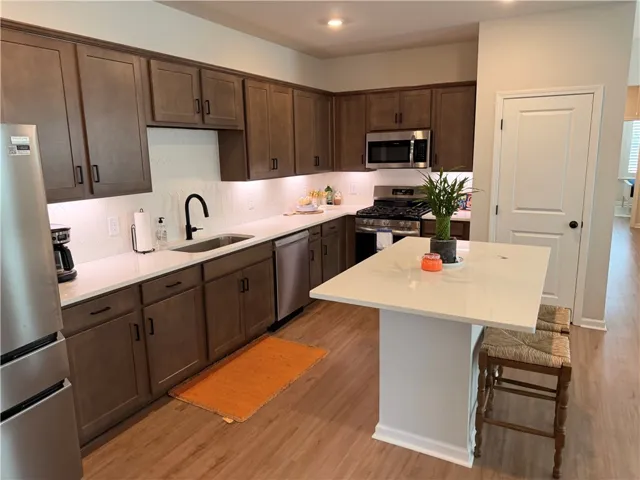 Culinary delights await in this modern kitchen with generous cabinet space with under-cabinet lighting over stone counters with tile splash, and integrated SS appliances that include a microwave over a 5-burner gas stove, and dishwasher. Kitchen island offers an added counterThe SS Gallery series Frigidaire refrigerator is negotiable.