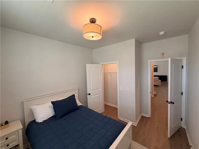Bedoom 2 features LVP flooring, WI  lighted closet,  and Plantation shutter treatments.