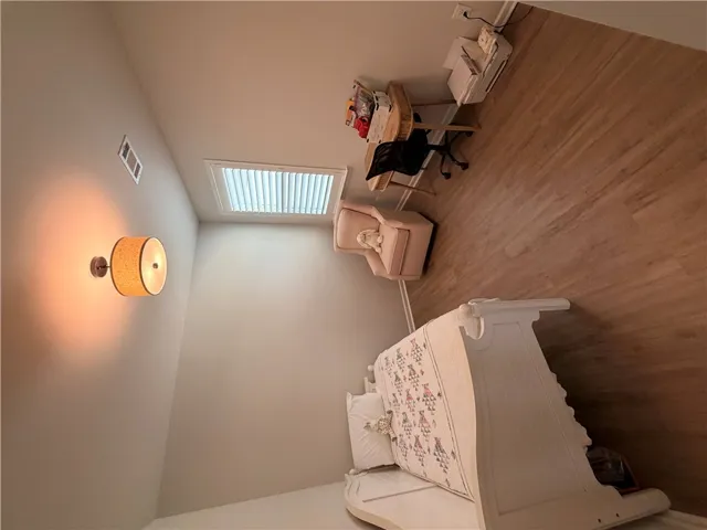 Bedroom 4. LVP floors, WI lighted closet, and plantation shutter treatments create an able and inviting atmosphere.