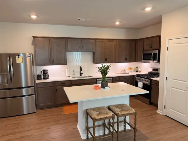Culinary creations come to life in this kitchen, featuring an island and stainless appliances.
