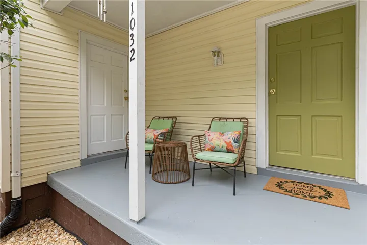 Welcome guests on this inviting front porch, adorned with durable siding and a charming entry door.