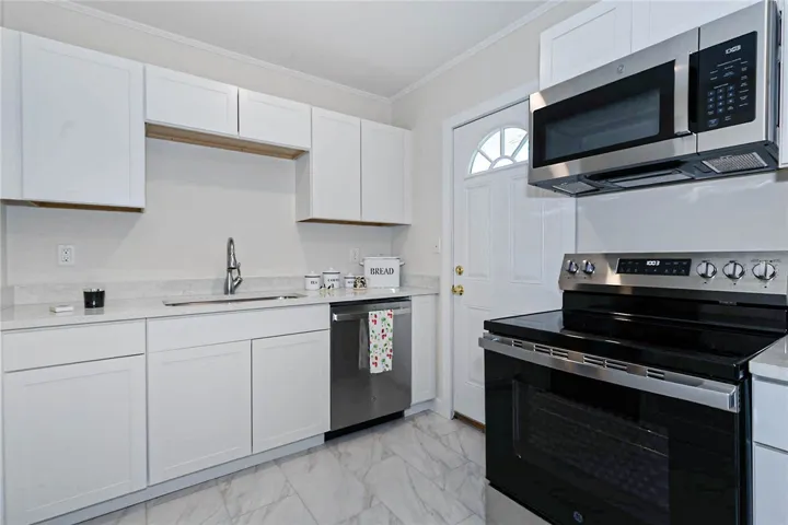 A well-equipped culinary space awaits with pristine cabinetry and modern appliances.