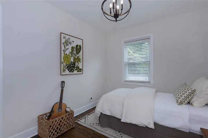 Heart Pine Hardwood floors and a striking modern chandelier define this naturally illuminated private bedroom. This bedroom has access to a side deck.