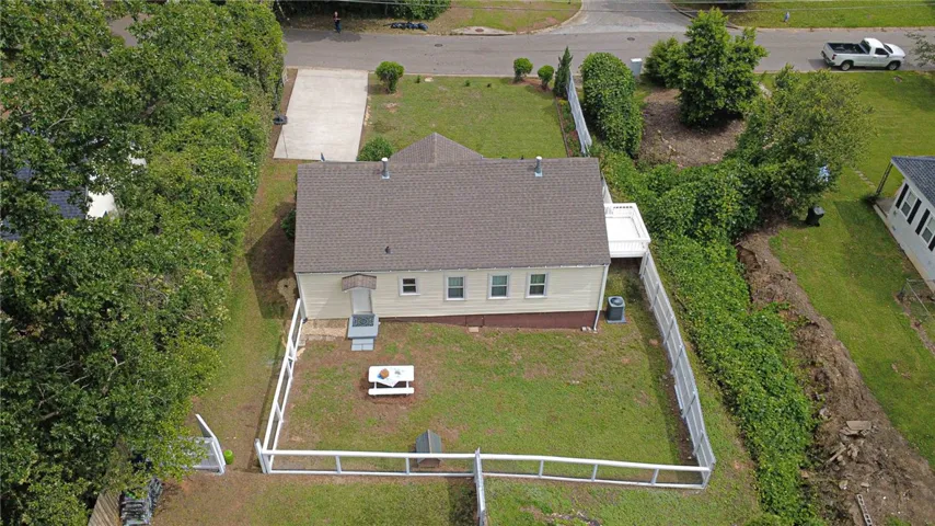 A well-maintained single-story residence with a fenced yard and a deck.