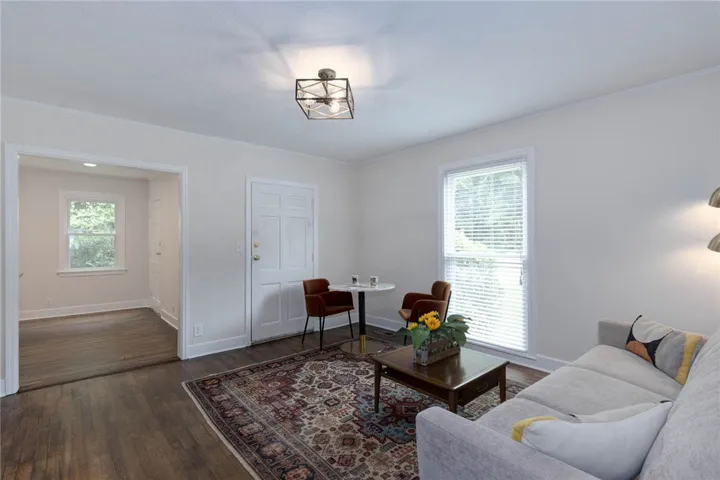 Hardwood floors and a patterned area rug define this welcoming living space.