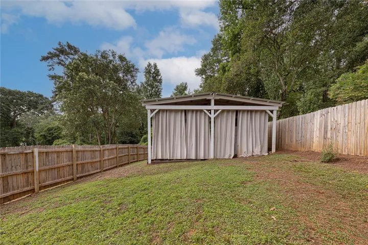 A private backyard oasis with a charming covered cabana.