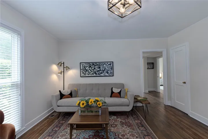 Rich hardwood floors welcome you into this light-filled living space, perfect for relaxation. Original oak hardwoods restored.